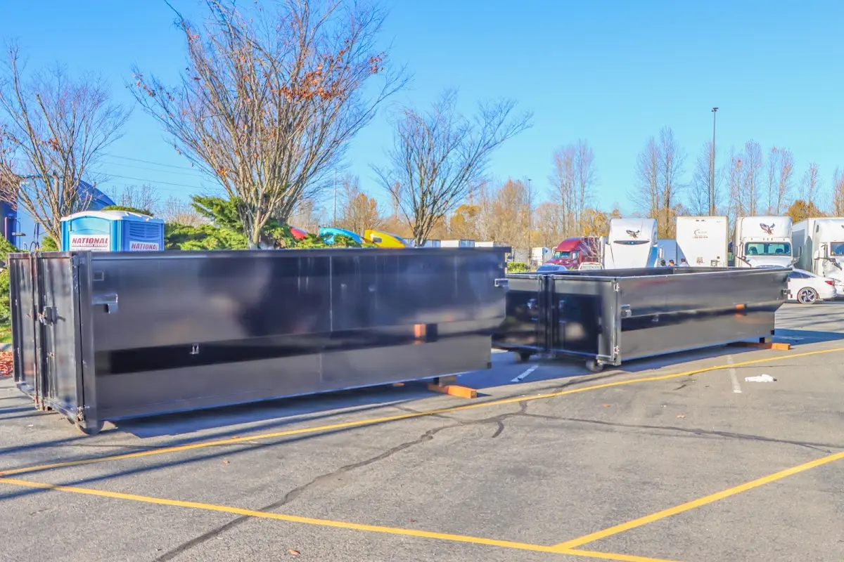 Professional dumpster rental service with roll-off container on residential driveway in Sauk Rapids